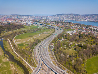 Fototapeta na wymiar Aerial view of highway in Switzerland leading to Zurich. Large intersection of motorway towards Zurich.