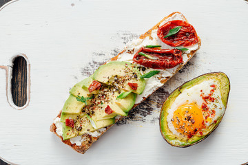 bruschettas with avocado and avocado with egg healthy breakfast