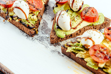 bruschettas with avocado tomatoes mozzarella sun-dried tomatoes and spices