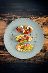 bruschettas with avocado tomatoes mozzarella sun-dried tomatoes and spices