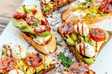 bruschettas with avocado tomatoes mozzarella sun-dried tomatoes and spices