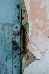 Old, rusty, iron, padlock on a wooden door. Locked. Forgotten. Outdated. Ancient. Decrepit. Closed.