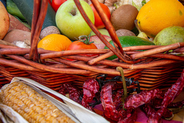 Set of fruits and vegetables placed in a wicker basket, lots of variety of color