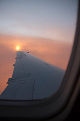 cloudy sunset sky over plane wing