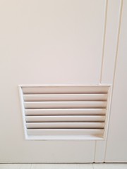 Closeup of beautiful door vent in bathroom copy space.
Air ventilation concept.