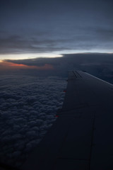 cloudy sunset sky over plane wing