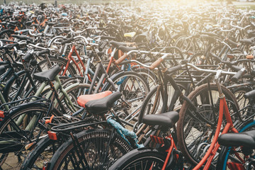 Large bicycle parking in Amsterdam, many bikes in sunlight, toned