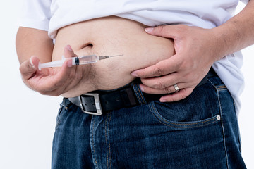 Obese men and are diabetics patient, are injecting insulin on the abdomen To control blood sugar...