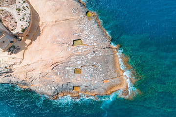 Xlendi Bay Salt Pans with waves crashing
