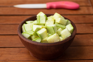 Diced Zucchini into a wooden bowl