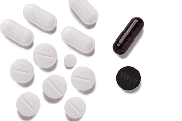 White pills with antivirus vaccine and black pills with covid-19 sign isolated on white background.