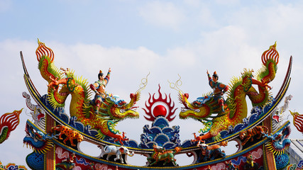 bright multi-colored sculptures of Japanese samurai dragons on the roof of traditional temples. religion in asia. a religious temple rises above a Chinese city. korean chinese japanese temples