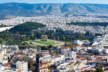 Fototapeta na wymiar view of the city of Athens with the ruins of the temple of zeus olympic with mountains on background