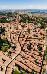 Spectacular aerial view of the old town of Volterra in Tuscany, Italy. View from above to the roofs and city. Panoramic beautiful vertical shot. Postcard concept.