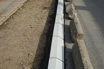Reconstruction of the sidewalk and replacement of old curbs. Construction zone