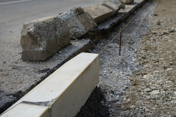 Reconstruction of the sidewalk and replacement of old curbs. Construction zone