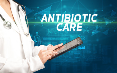 doctor writes notes on the clipboard with ANTIBIOTIC CARE inscription, medical diagnosis concept