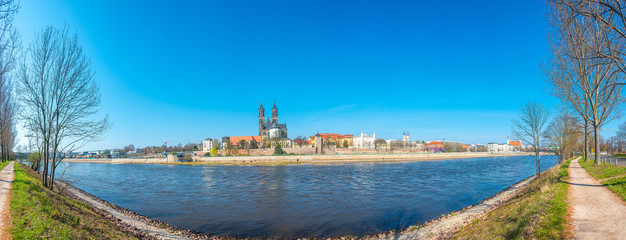 Panoramic view over downtown of Magdeburg, old town, Elbe river and Magnificent Cathedral at early Spring, Germany, at sunny day and blue sky, wide angle