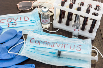 2019 new  danger disease coronavirus (2019-nCoV). Fasical mask with blood test tube. Find virus...