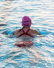 Swimmer swiming breaststoke in a pool