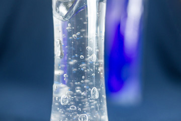 Two disinfectants to fight the transparent covid virus with another purple with blue background
