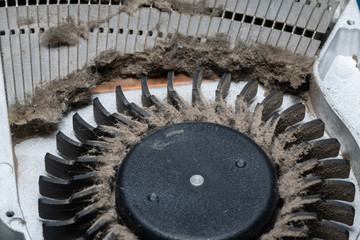 Dust on the computer pc processor cooler with mainboard and computer case fragment. Selective focus. Macro photo. Video card.