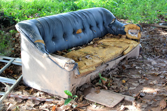 Old broken sofa thrown in the trash Stock Photo | Adobe Stock