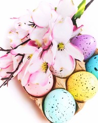 easter eggs in a basket with flowers