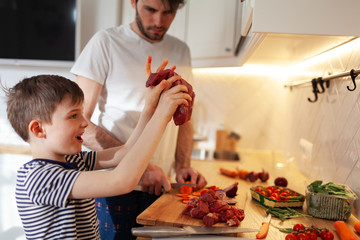 Isolation With Fun, Happy Father And His Little son cooking in Kitchen, Staying At Home During Quarantine