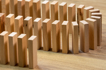 closeup of lined wooden dominoes, on wooden top