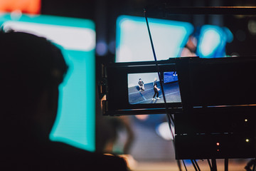 Person filming a show on the stage with professional camera