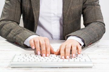 Close up woman hands typing on computer keyboard