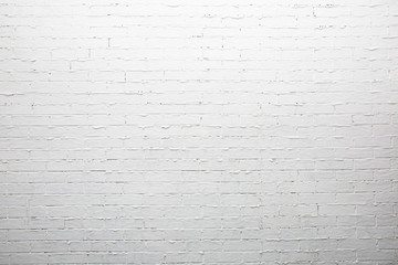 White brick wall with thick uneven joints.