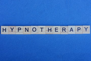 word hypnotherapy made from gray letters lies on a blue background