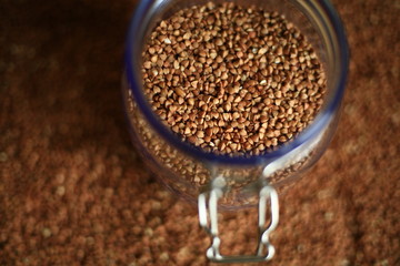 buckwheat in a glass jar on blurred background 