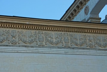 part of an old brown concrete wall of a building with a pattern against a blue sky