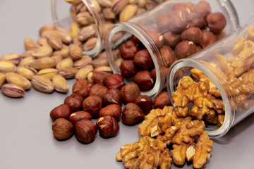 hazelnut, walnut and pistachio nut. mixed assorted nuts in glass box on light background.