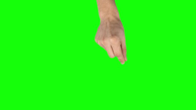Man hand is performing spread and single tap at tablet screen gesture on green screen. Close up
