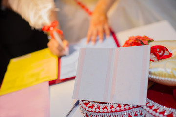 Hands of Caucasian wedding people signing the document on wed ceremony, close up view . The...
