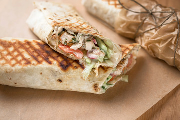 Doner kebab Shawarma cut with filling on parchment paper