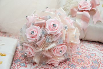 Fototapeta na wymiar Faux Pink roses and ivory bouquet 