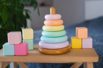 Children's toys made of natural materials. Wooden cubes and a pyramid.