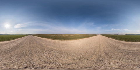 Fototapeta na wymiar full seamless spherical hdri panorama 360 degrees angle view on gravel road among fields in spring day with clear sky in equirectangular projection, ready for VR AR virtual reality content
