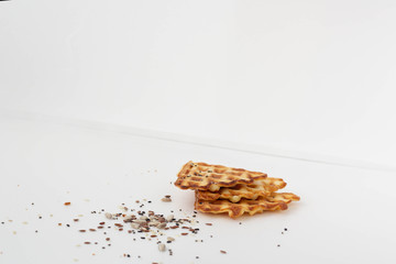 Waffle cookies and seeds isolated on a white background.
