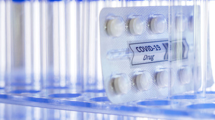 The pack of the Covid-19 drug or coronavirus drug in between the test tubes