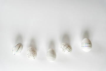 White easter eggs with silver pattern on white