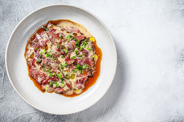 tataki beef with fresh green onions. White background. Top view. Copy space