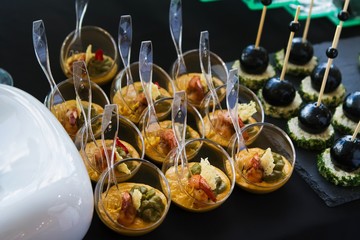 small, fresh and tasty snack dishes in glasses, fashionably served by catering service, celebration party banquet, healthy food concept