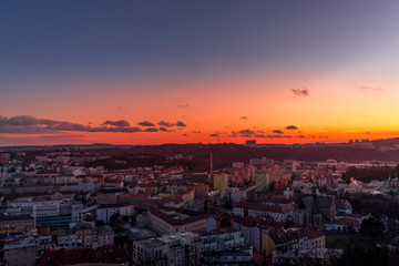 Day to night time-lapse when Brno city square and surroved area goes from sunset when sunshine change city colors to orange through sunset to night when city light goes on captured 4k high resolution