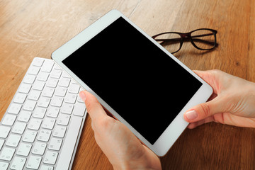 female hands holding smart phone on wooden background  , place for your text  .